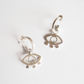 A pair of eco silver mini hoop earrings with eye motif.