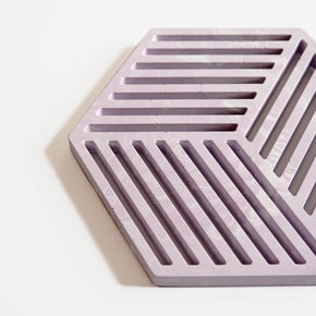 Close up of a hexagonal jesmonite trivet in cool lilac with a subtle marbled finish handmade by Klndra for Curious Makers