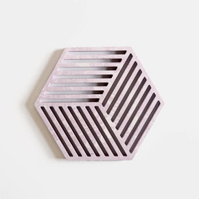 A hexagonal jesmonite trivet in cool lilac with a subtle marbled finish handmade by Klndra for Curious Makers