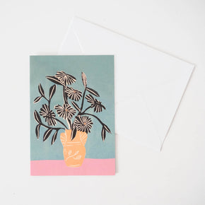 Greeting card featuring beautiful blooms in a peachy vase and white envelope.