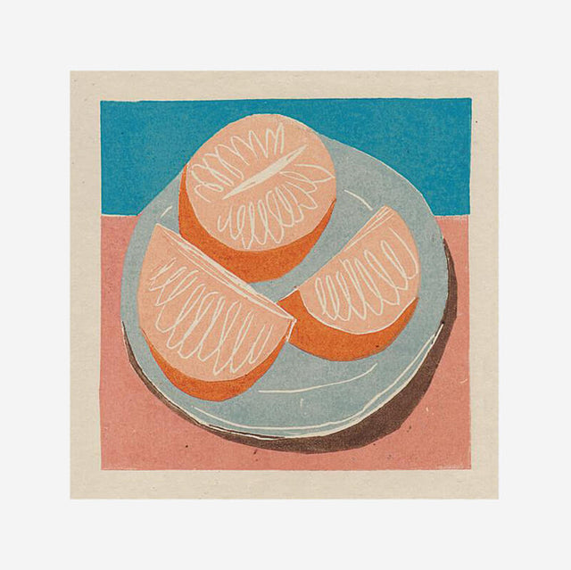 Freshly sliced oranges on a blue plate. A print by Luiza Holub