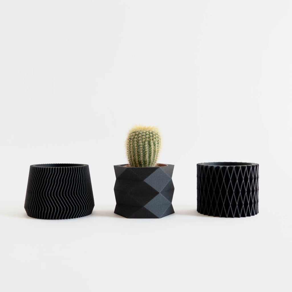 Set of 3 black mini 3D printed planters with geometric and diamond designs.