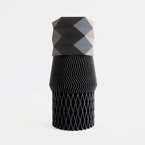 3 black mini 3d printed diamond shaped planters stacked on top of each other.