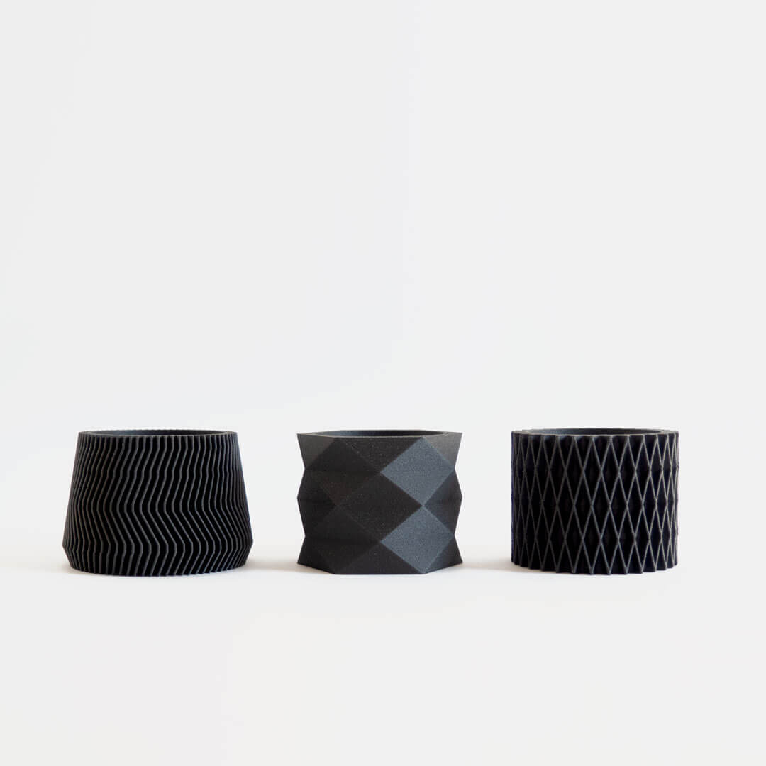 Set of 3 black mini 3D printed planters with geometric and diamond designs.