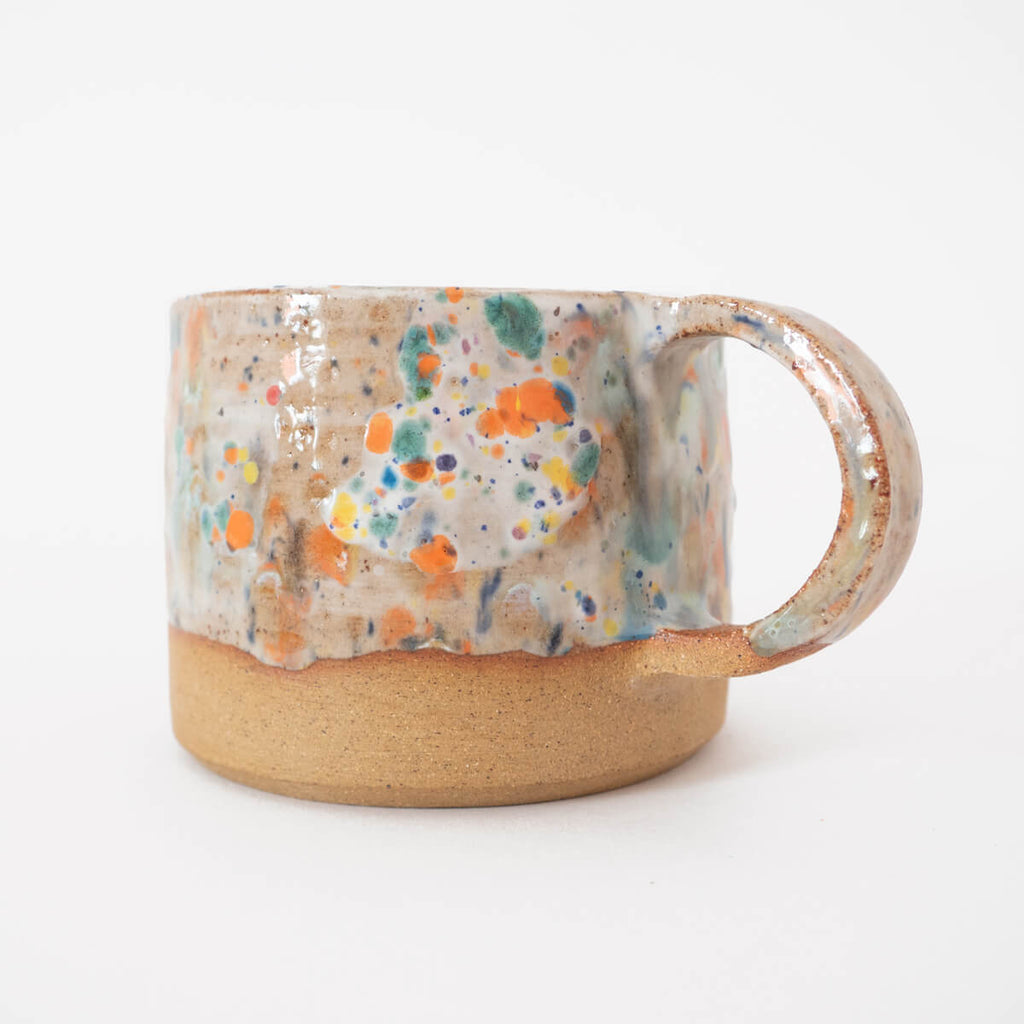 Hand thrown stoneware mug with a beautiful drippy glaze and modern handle. 