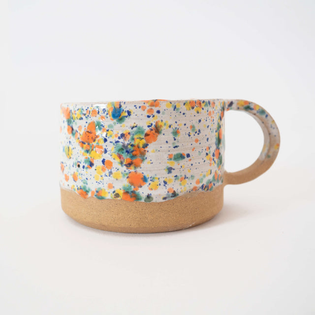 Hand thrown stoneware mug with a cute speckled pattern and drippy glaze.