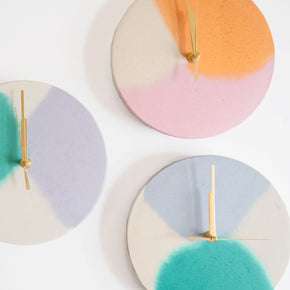 A group of round concrete wall clocks by Studio Emma for Curious Makers