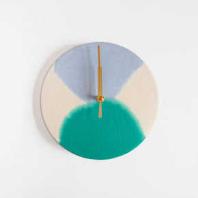 Round concrete wall clock with a sage and lilac pattern by Studio Emma for Curious Makers