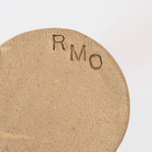 Makers mark on the bottom of a hand thrown stoneware mug by RMO Studio for Curious Makers
